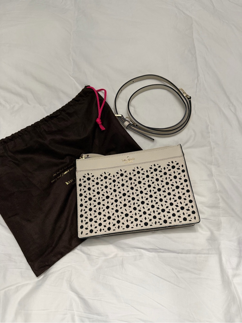kate spade cream laser-cut crossbody with black underlay